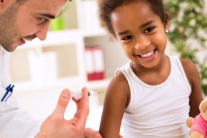 Little happy girl get an injection